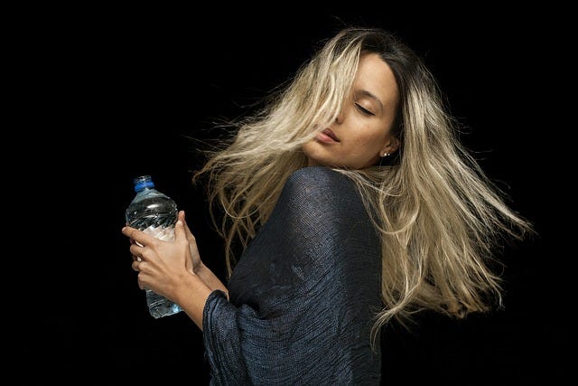 Woman, model, that waterbottle, long highlighted hair, look of pleasure abandon