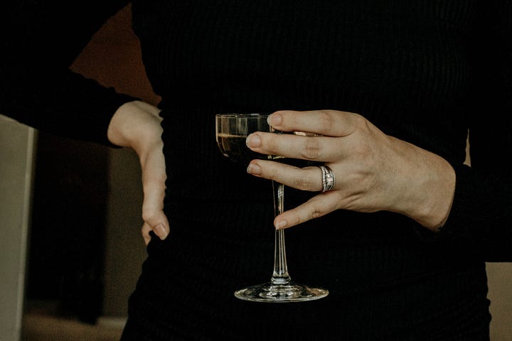 The author holding a cocktail glass.