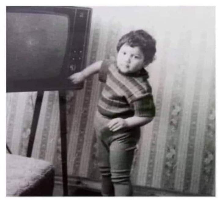 A child in the 1960s or 70s acting as the remote control.