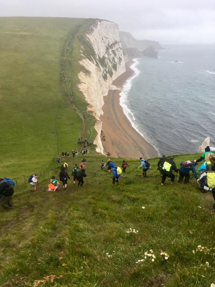 Hikers climbing hills for the Jurassic Coast Might Hike in 2019