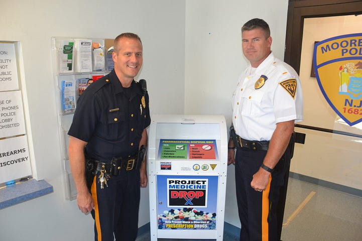 Left to right, Officer Walt Walczak and Lt. Howard Mann Jr. stand beside the newly implemented drug drop box.