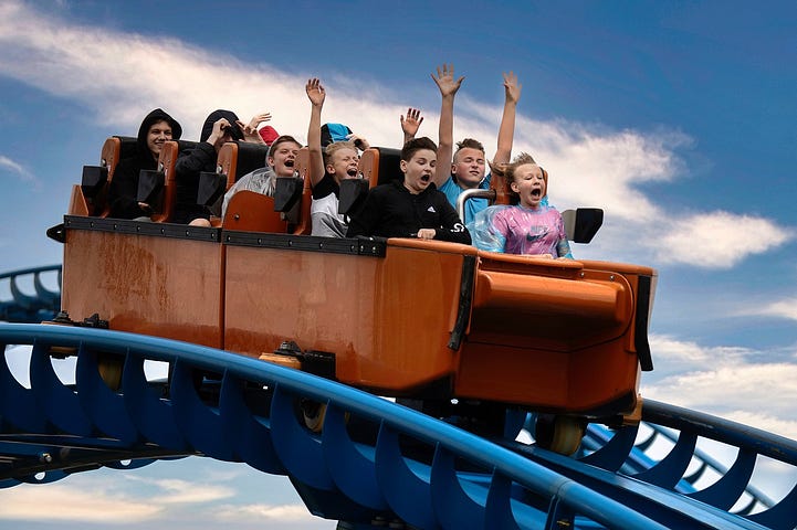 People ride a rollercoaster