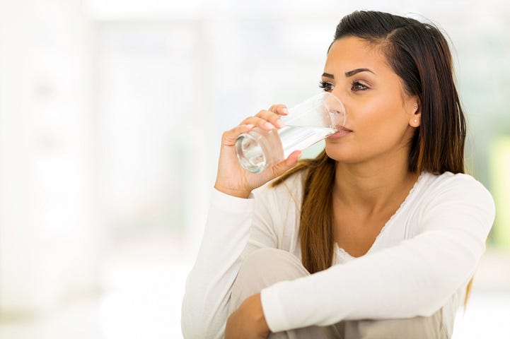 Woman Drinking Filtered Water from Bottleless Water Dispenser