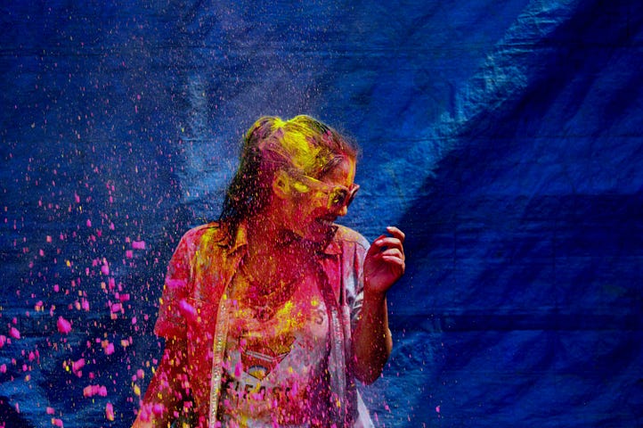 Woman playing Holi, the Indian festival of colors and Spring.