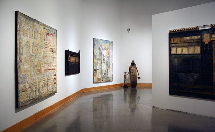 A photo of the inside of one of the Eleanor D. Wilson’s gallery spaces, on the walls and in the room are mixed media paintings by Lenny Lyons Bruno.