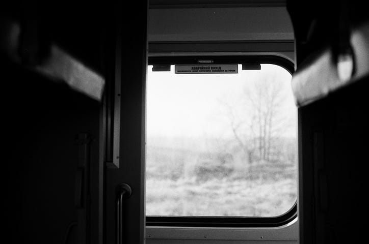 View from inside a train cabin, looking out the window