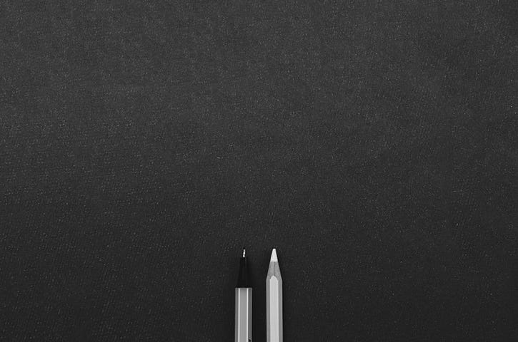 black and white photo of a pen and pencil tip