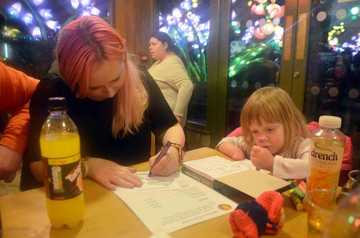 Justine and her niece, colouring in at a table