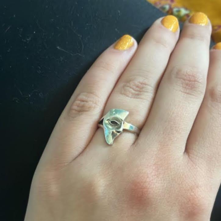 A silver ring shaped like the Phantom of the Opera’s half mask