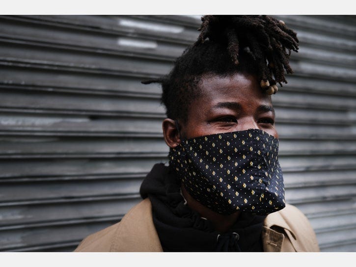 A black New Yorker wears a face covering