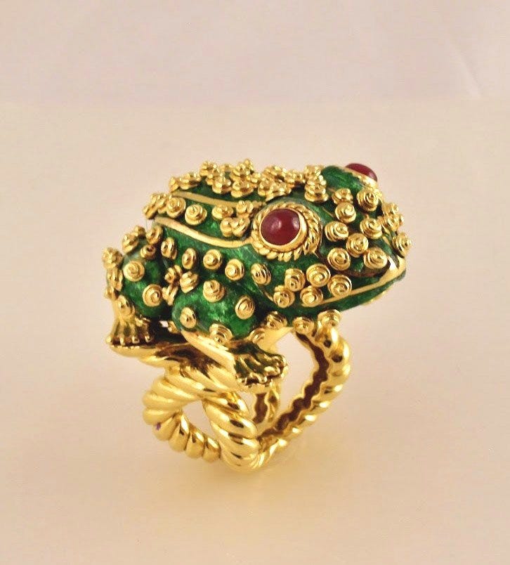 Green and gold frog ring with red jemmed eyes.