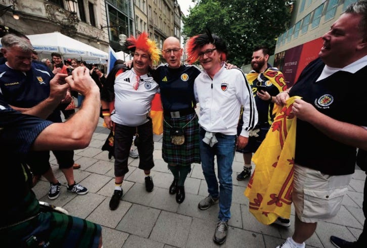 Photo of John Swinney posing with German football fans surrounded by Scotland football fans