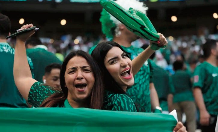 photo of two female Saudi Arabia fans celebrating