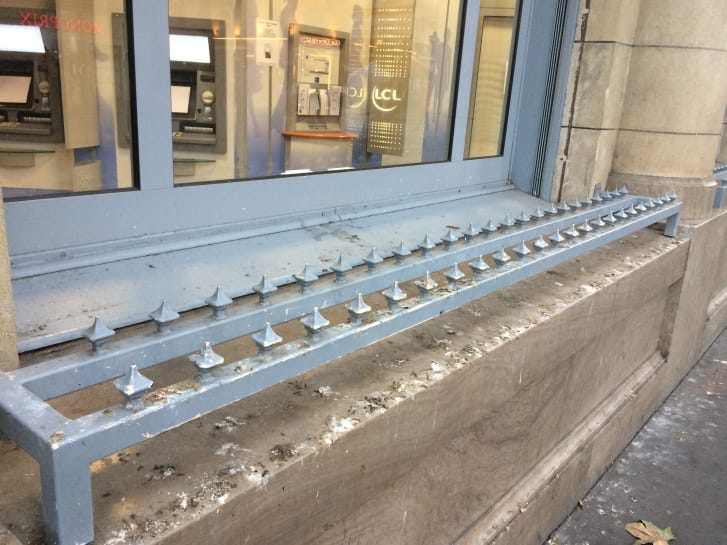 two layers of spikes attached on a ledge to prevent siting