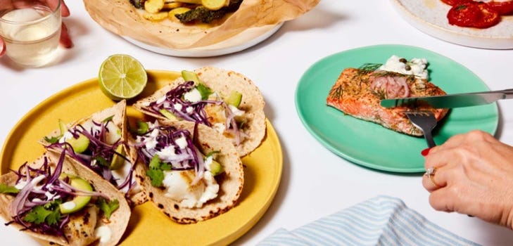 Fish tacos and salmon fillet on colorful plates