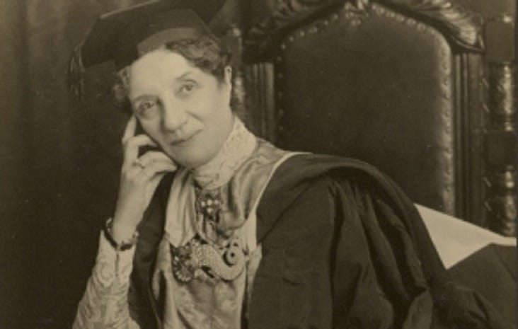 Portrait of Horniman donning a graduation cap and gown, seated on a chair.