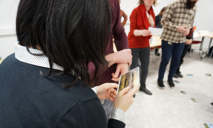 Participants looking at different pictures of grasslands relating to their values (Photo by Lea Pöllmann).