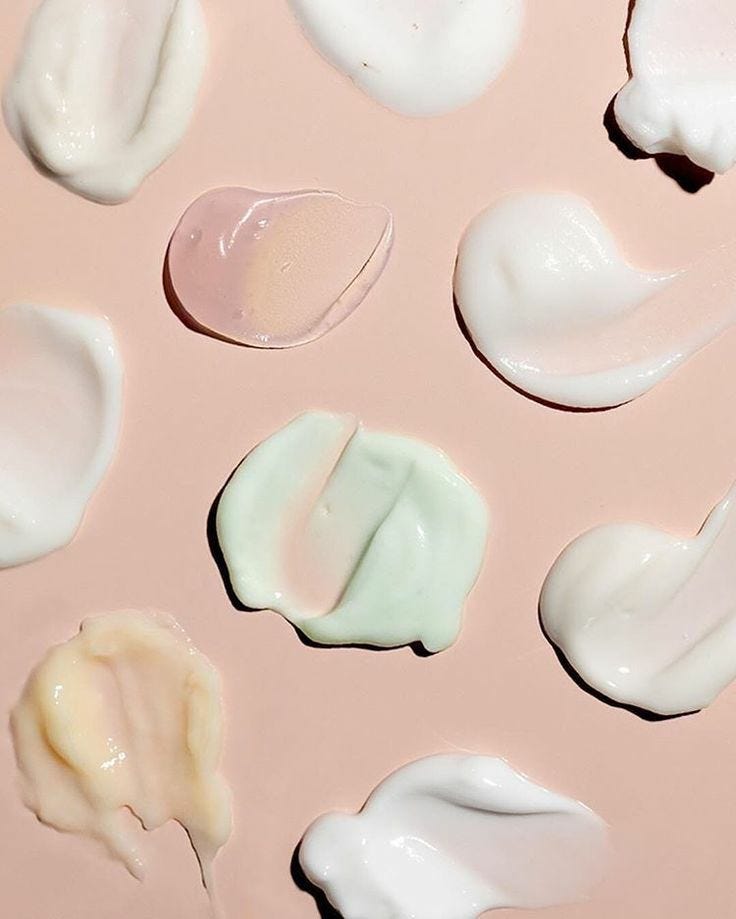 Different textures of moisturizers smeared on a flat surface