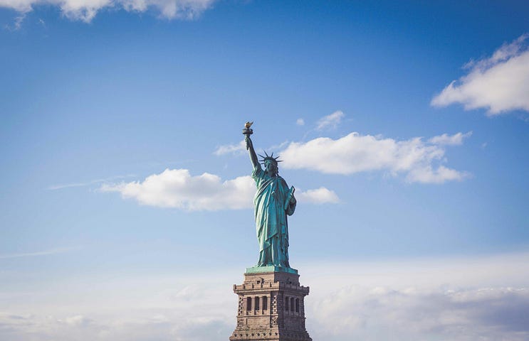 A photo of the Statue of Liberty, framed to look like it’s floating alone in the clouds.