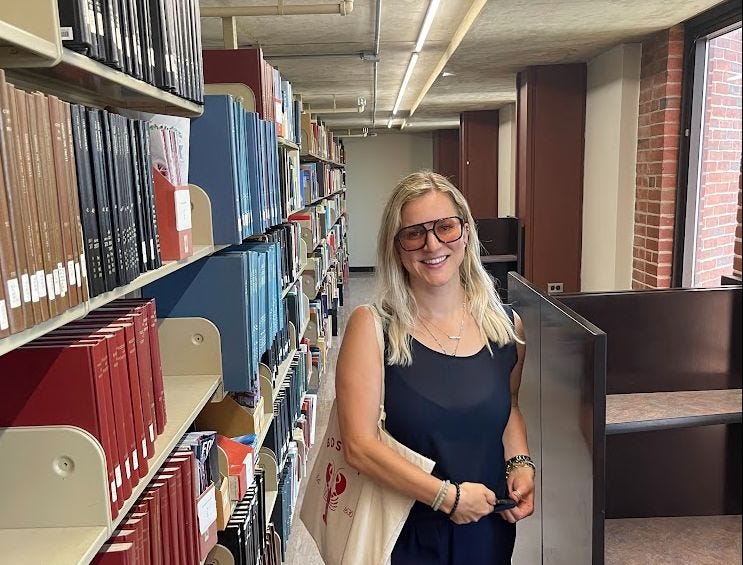 women standing next to books