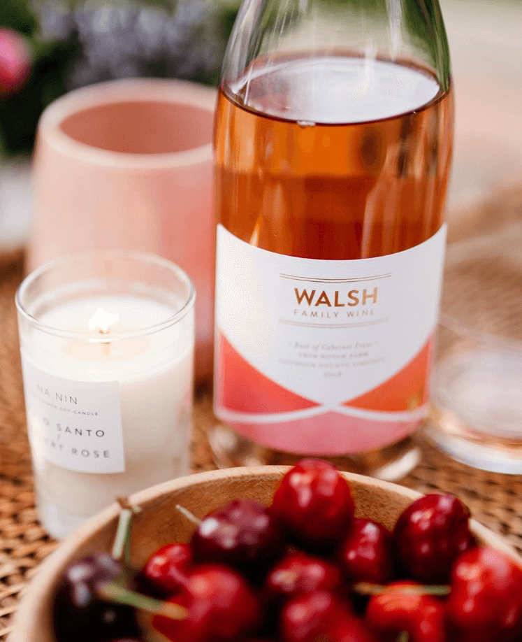 A picture of Walsh Family wine brand on top of a table with cherries.