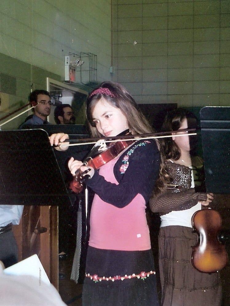 Author, as a child, playing a violin