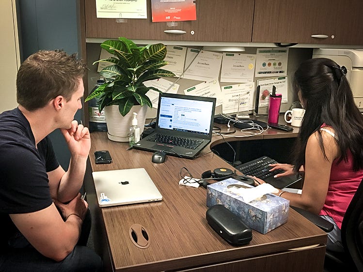 Image of a two people at a desk, involved in a website user testing session.