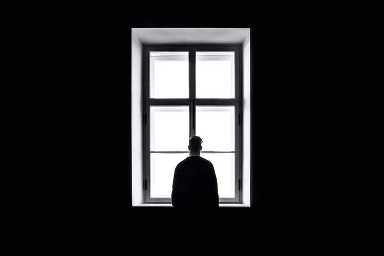 A man staring out a window