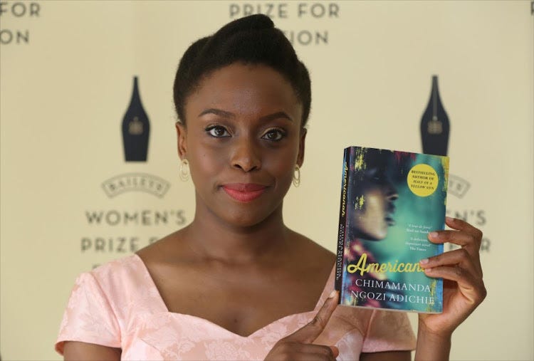 Photo of Chimamanda Ngozi Adichie with with her novel “Americanah” on her left hand.