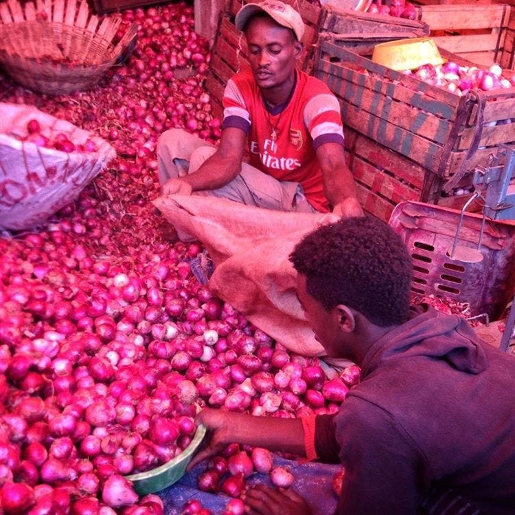 @sincerelyhilina: Men selling onions - main ingredient in Ethiopian cuisine - as Market Flocks on Easter eve.