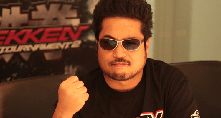 Image of Katsuhiro Harada pictured with a Tekken Tag Tournament 2 Display