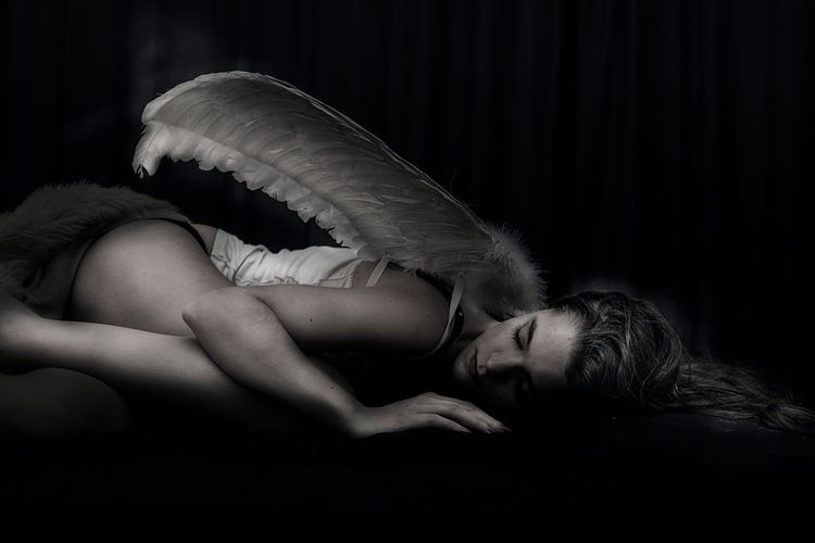 fallen angel, woman with wings lying on the ground