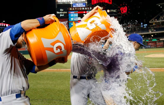 Chicago Cubs' Ben Zobrist, left, and David Ross douse Albert Almora Jr. after a baseball game against the Washington Nationals at Nationals Park, Tuesday, June 14, 2016, in Washington. The Cubs won 4-3. (AP Photo/Alex Brandon)