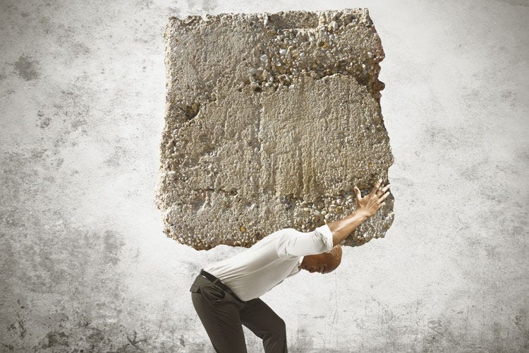 Man carrying huge block of stone on his shoulders: Regret