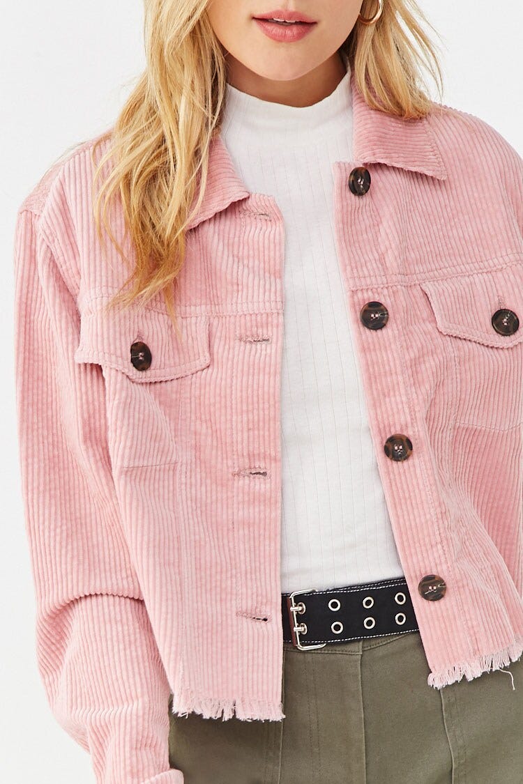 A Forever 21 model wearing a light pink corduroy jacket over a white t-shirt. The jacket has brown buttons on the pockets.