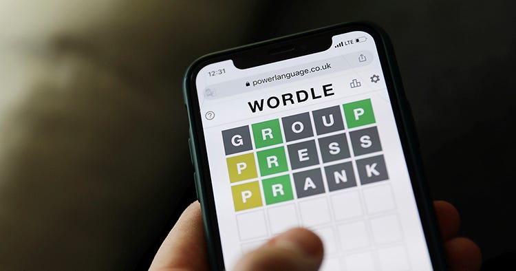 A smartphone displays the Wordle game with guesses: GROUP, PRESS, PRANK. Green and yellow letters indicate correct or misplaced letters.