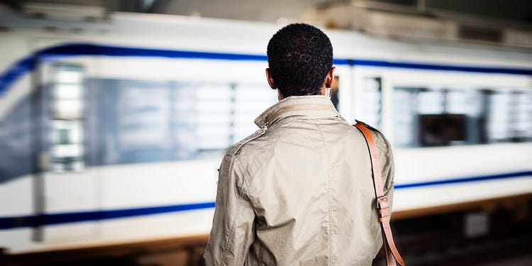 A guy standing in front of metro, looking afar, seeking vision, THE VISION CODE