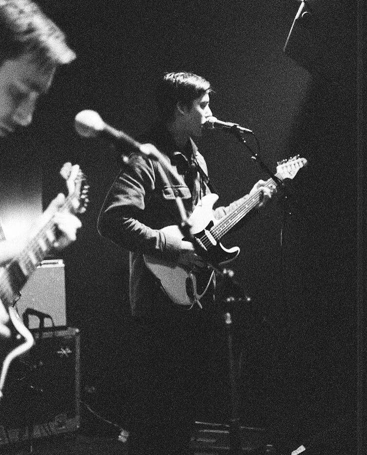 Picture of a man singing and playing guitar.