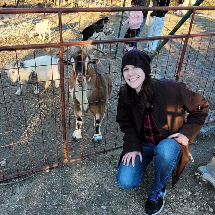 Rachelle is pictured with goats at a local family farm in Texas