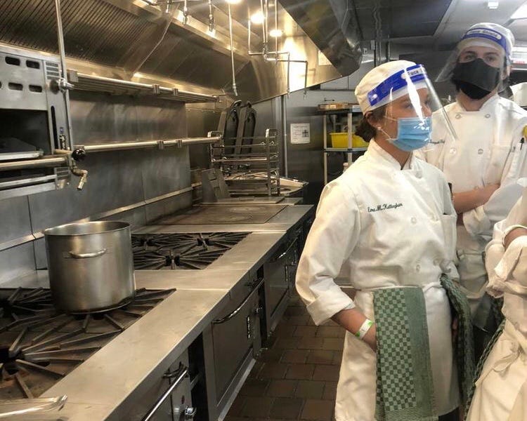 Students at the CIA prepare for class in the kitchen.