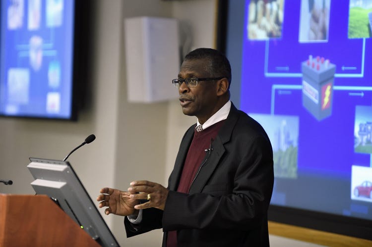 Inventor Lonnie G. Johnson speaks in front of a microphone.