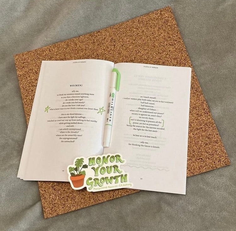 A copy of Manipulated Memories is lying open. A sticker that reads “Honor Your Growth” lays on top of the book, along with a green pen.