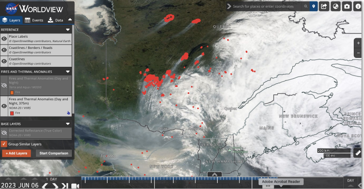 A satellite image of Maine and an eastern portion of Canada with clouds and red splotches.