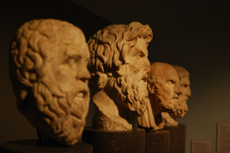 four statues of greek philosopher’s heads