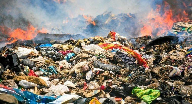 Image of waste clothes burning in a landfill