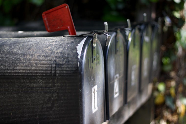 Five mailboxes in a row.