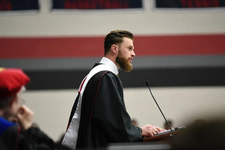 Side view of Kansas City Chiefs team member Harrison Butker addressing at podium during commencement address at Benedictine College in Atchison, Kansas.