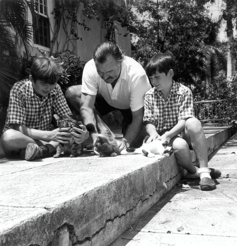 Hemingway with sons Patrick and Gregory and kittens. From the Ernest Hemingway Photograph collection: John F. Kennedy Presidential Library.
