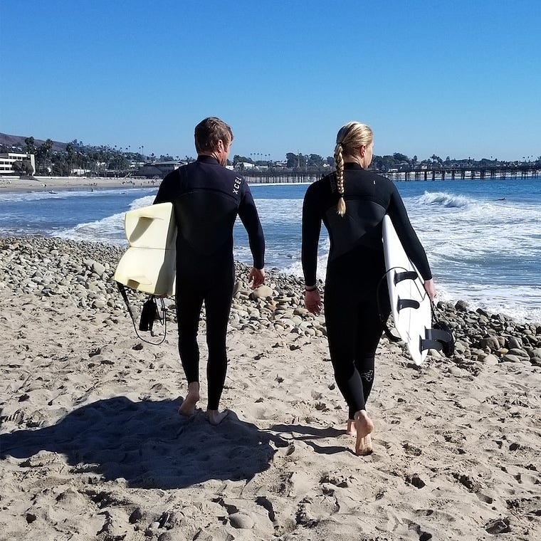 Cat and her husband on their way to surf in Ventura, California. Photo Credit: Deirdre Darst