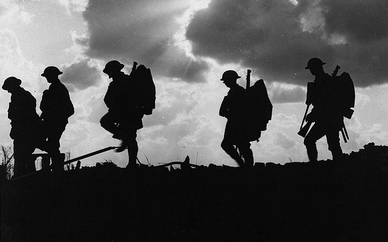 Silhouetted troops marching